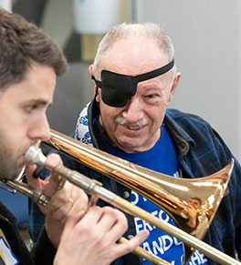 Rupert Whitehead, a trombonist with the Royal Philharmonic Orchestra, plays next to Terry Taylor, who had a stroke three years ago.