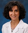 Dr. Nadine Abi-Jaoudeh, pictured in her lab coat, is a board-certified, fellowship-trained UCI Health radiologist who specializes in diagnostic, vascular and interventional radiology. 